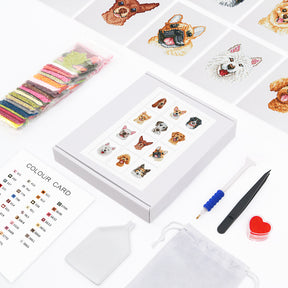 Mini Kunst embroidery kit with colorful threads, tools, color card, and dog designs.