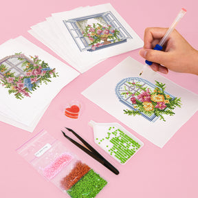 FloraleFenster diamond painting kit with floral designs, tools, and beads on a pink background being used for mini kunst creation.