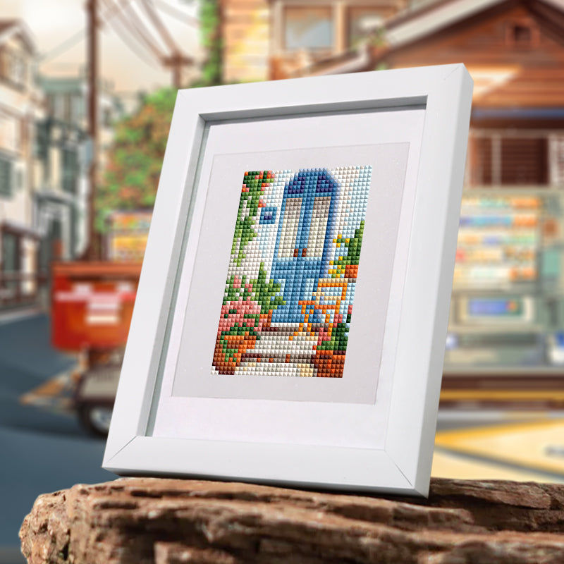 Willkommen Zwei 12er SET - Diamond Painting framed artwork in a white frame, featuring colorful mini art design in an urban background.