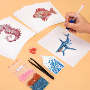 Creating mini art with Meeresbewohner 12er SET Diamond Painting, featuring sea creatures and vibrant diamond pieces.