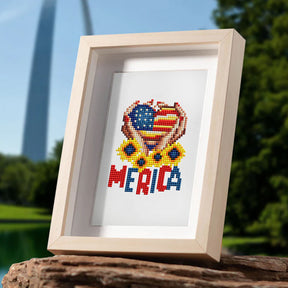 Framed USA-themed diamond painting with "MERICA" text in nature setting.