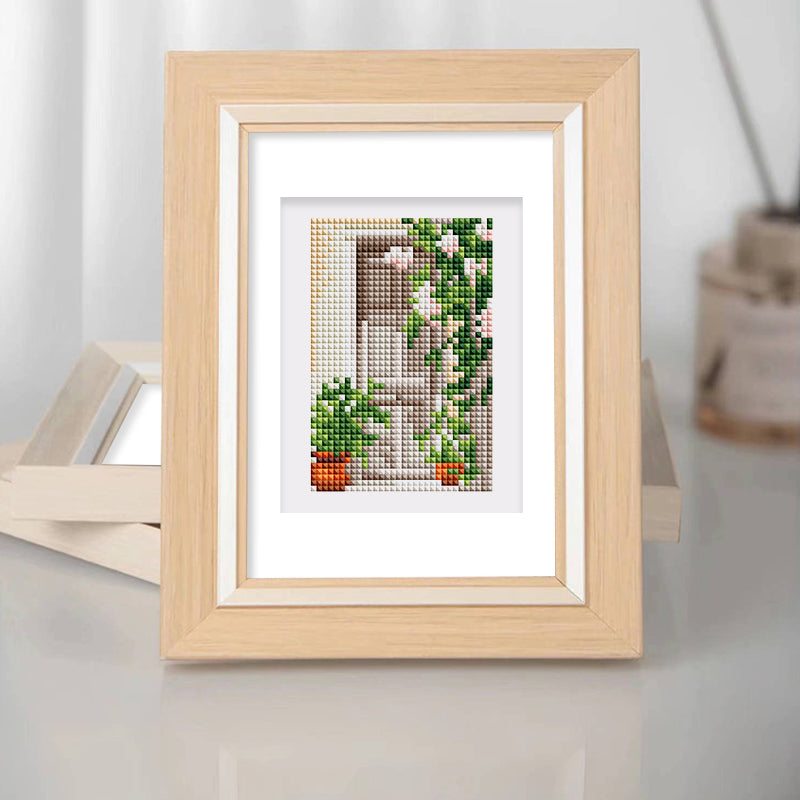 Framed diamond painting featuring a scenic view with greenery and potted plants, perfect for mini kunst and home decor.