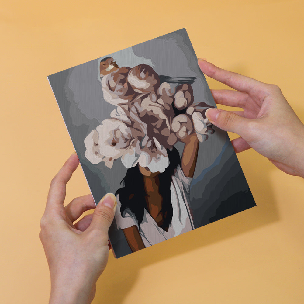 Person holding a painting of a woman with her face covered by flowers and birds, part of the Blumenhaar Edition Zwei 6er SET - Malen nach Zahlen, Mini Kunst.