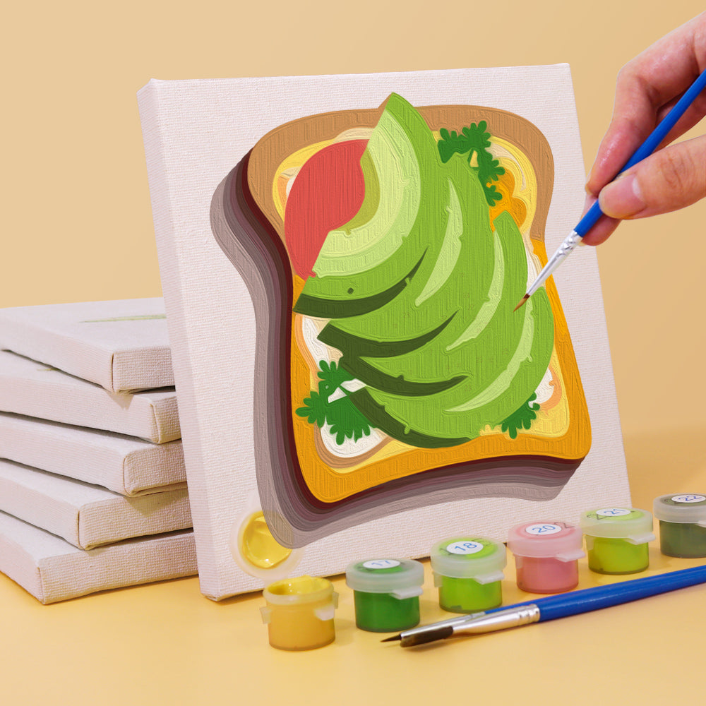 Painting by numbers kit from Küchen Edition Zwei 6er SET, showcasing a canvas with avocado art and mini paint containers. Mini Kunst DIY painting set.