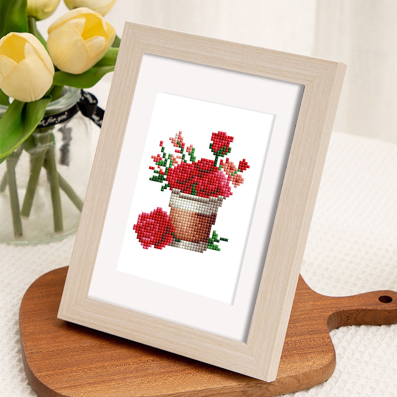 Framed diamond painting of red flowers in pot, Love Edition 12er SET, on wooden board next to yellow tulips, mini Kunst art.