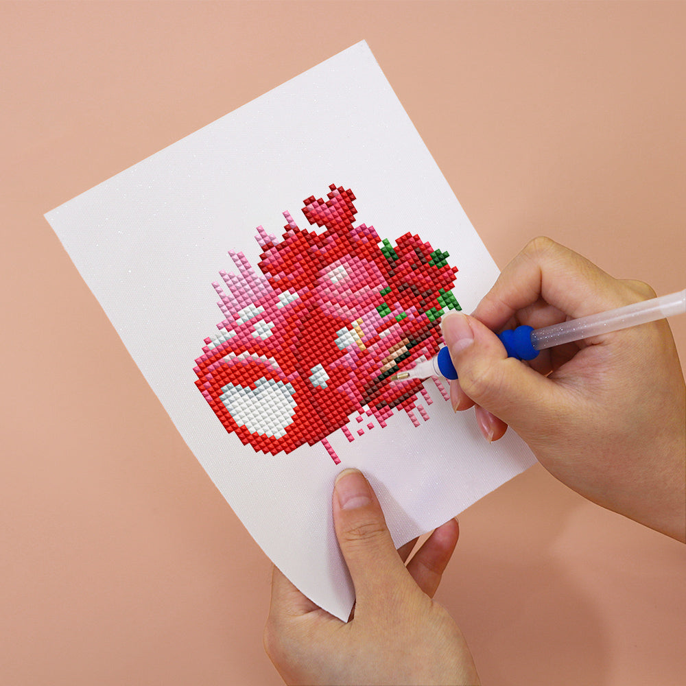 Person creating a heart-themed artwork using a diamond painting kit from the Love Edition 12er SET - Mini Kunst.