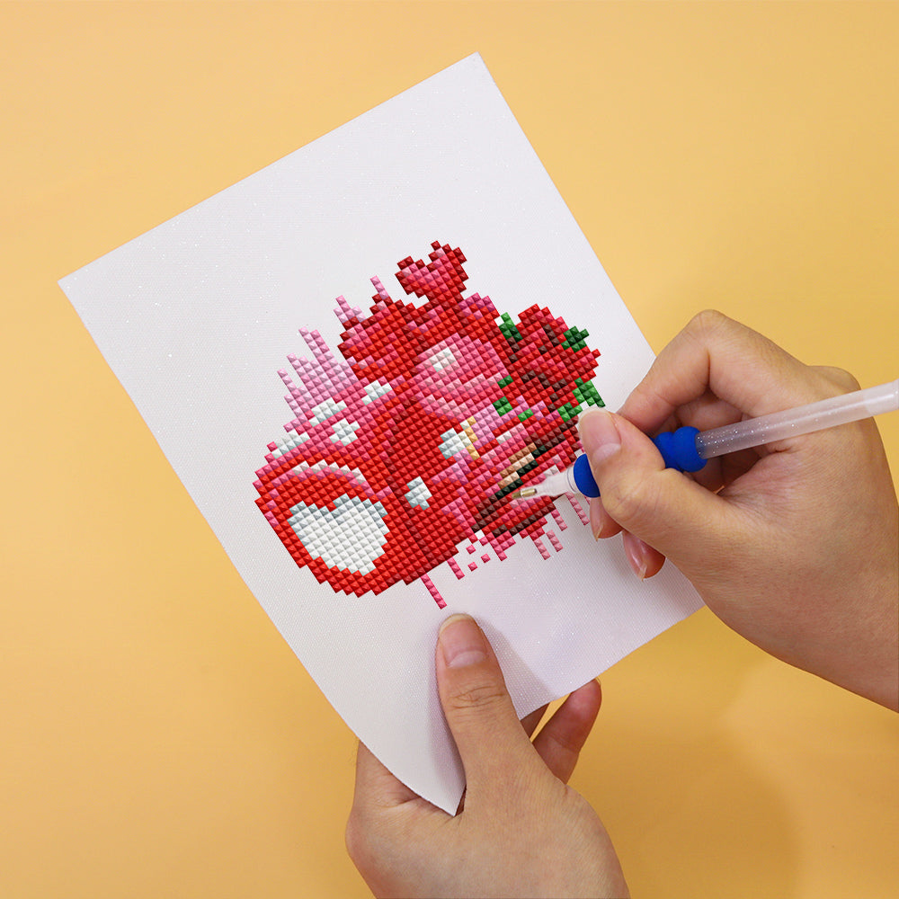 Person crafting a heart-shaped diamond painting on a Love Edition 12er SET canvas, showcasing mini kunst creativity.